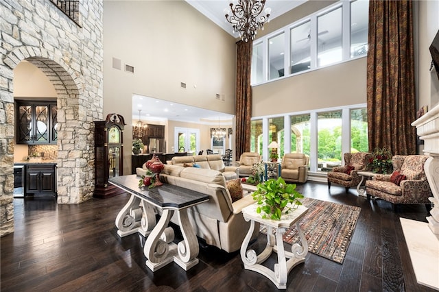 living room featuring dark hardwood / wood-style flooring and a towering ceiling