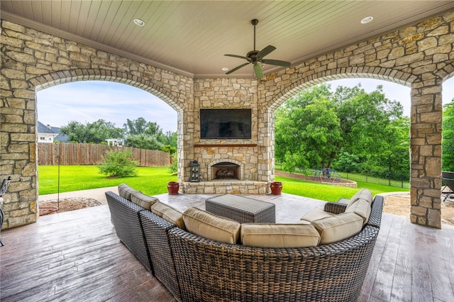 view of patio featuring an outdoor living space with a fireplace and ceiling fan