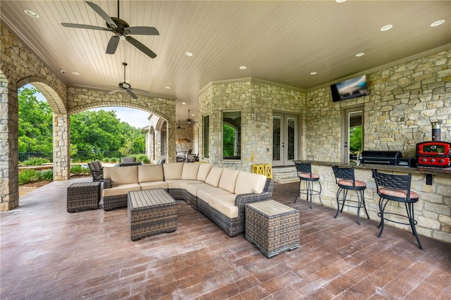 view of patio featuring outdoor lounge area, french doors, ceiling fan, area for grilling, and a bar