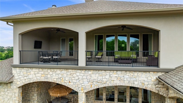 rear view of house with ceiling fan and a patio