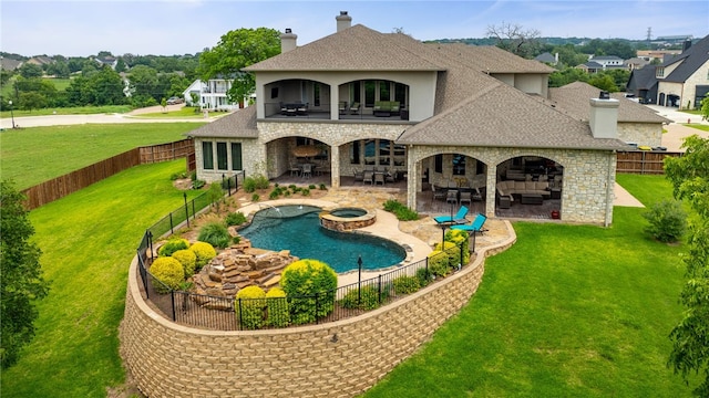 back of property featuring an outdoor living space with a fireplace, a yard, a patio area, and a pool with hot tub