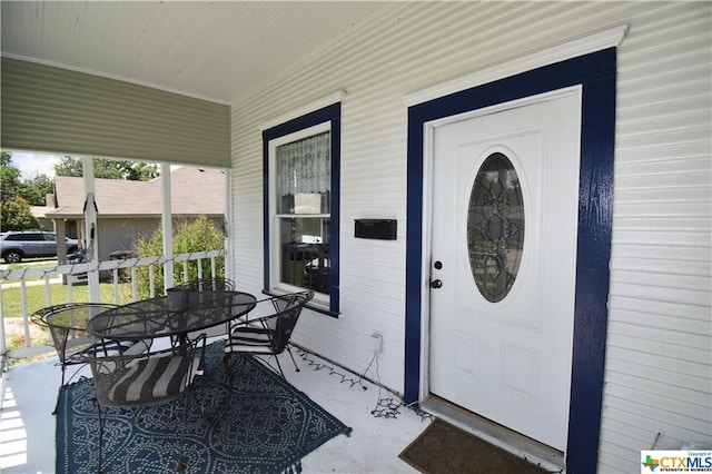 entrance to property featuring covered porch