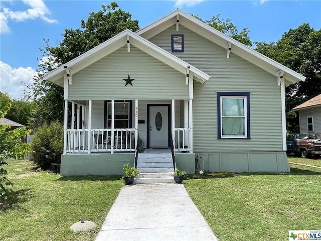 bungalow-style home featuring a porch and a front lawn