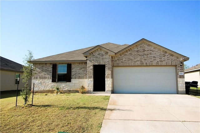 view of front of house with a garage and a front yard