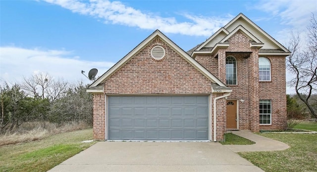 traditional-style house with a front yard, concrete driveway, brick siding, and an attached garage