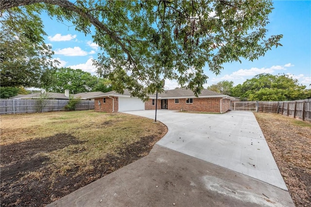 view of front of property with a garage and a front lawn