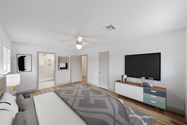 bedroom with ensuite bath, ceiling fan, and wood-type flooring