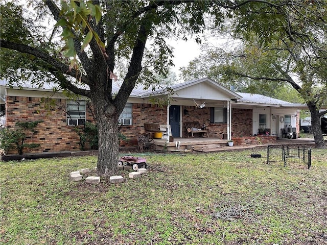 ranch-style home with a front yard and a porch