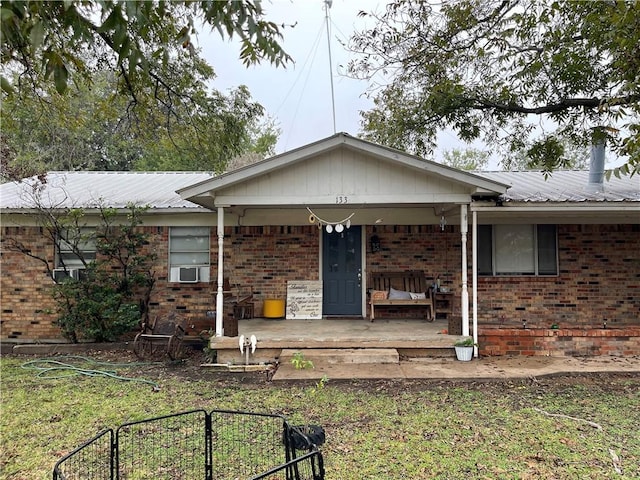 view of front of house with cooling unit and covered porch