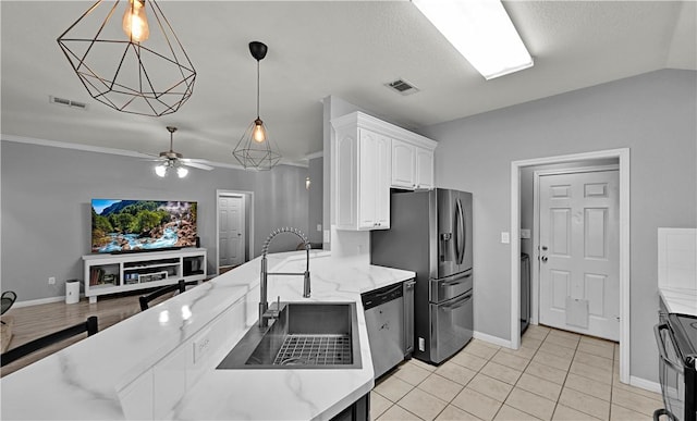 kitchen featuring visible vents, light stone countertops, stainless steel appliances, white cabinetry, and a sink