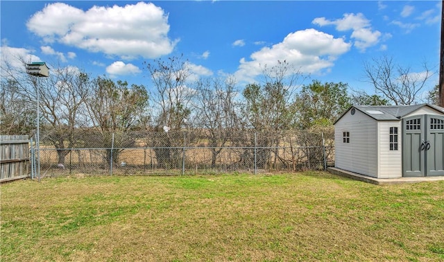 view of yard with a fenced backyard, a storage unit, and an outdoor structure