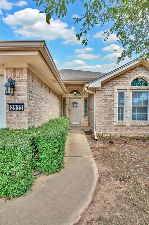 property entrance with brick siding