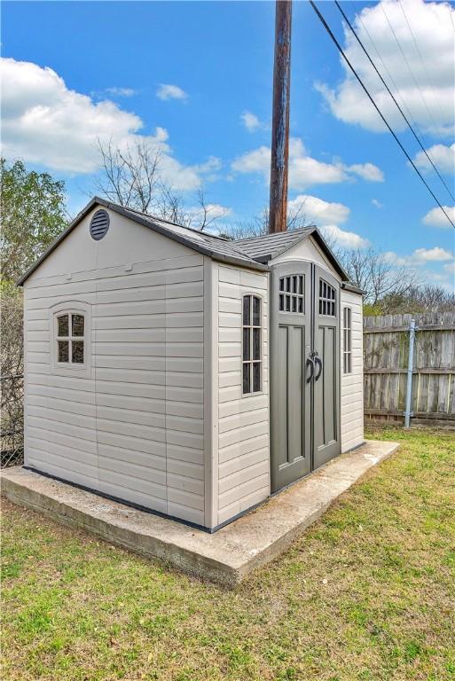 view of shed with fence