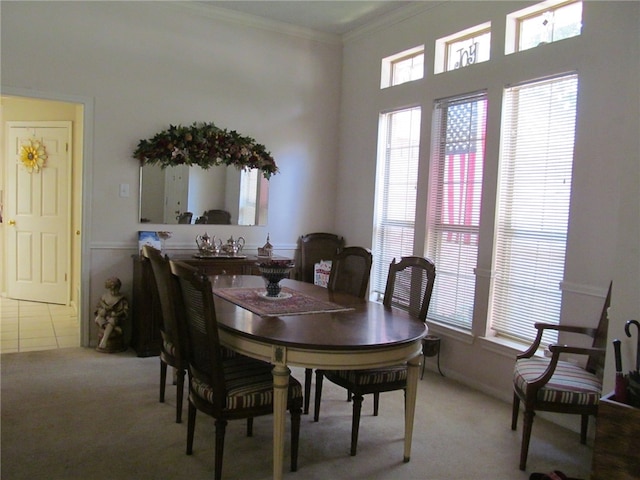 dining room with carpet floors and ornamental molding