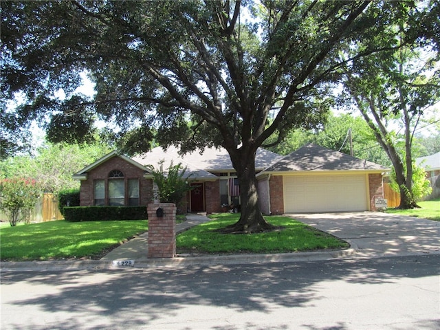 ranch-style house featuring a front lawn and a garage