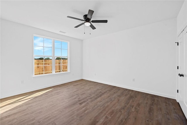 empty room featuring ceiling fan and dark hardwood / wood-style flooring