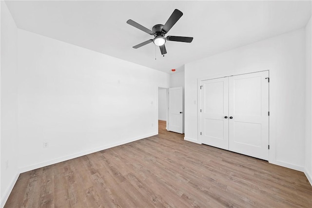 unfurnished bedroom with ceiling fan, light hardwood / wood-style floors, and a closet