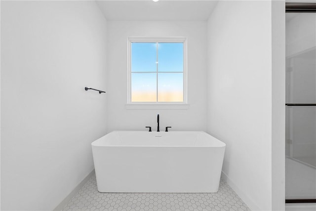 bathroom featuring a bathing tub and tile patterned flooring