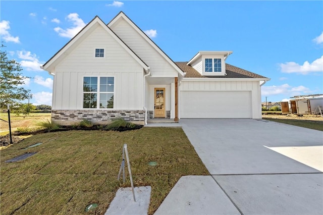 view of front of property with a garage and a front yard