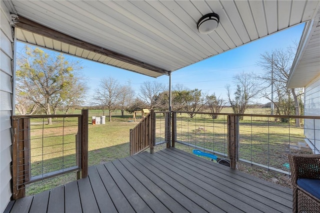 deck featuring a rural view and a lawn