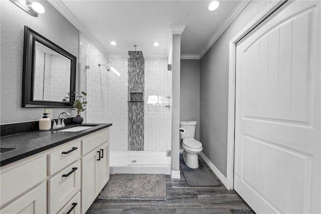 bathroom featuring a sink, toilet, ornamental molding, and a shower stall