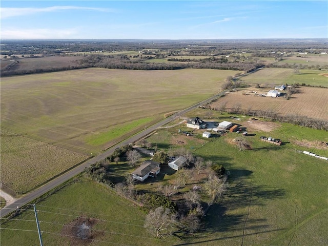 birds eye view of property with a rural view