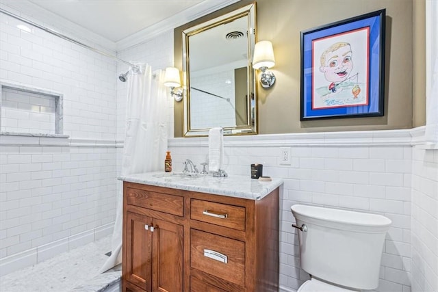 bathroom with toilet, vanity, tile walls, and ornamental molding