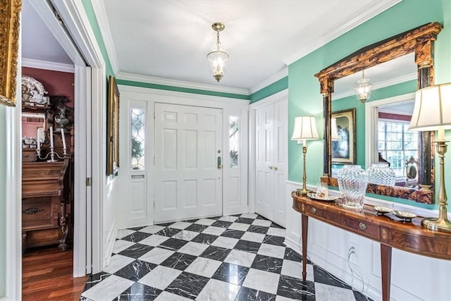 foyer featuring ornamental molding