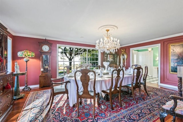 dining space featuring crown molding, dark wood-type flooring, and a notable chandelier