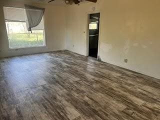 spare room featuring ceiling fan and dark hardwood / wood-style floors