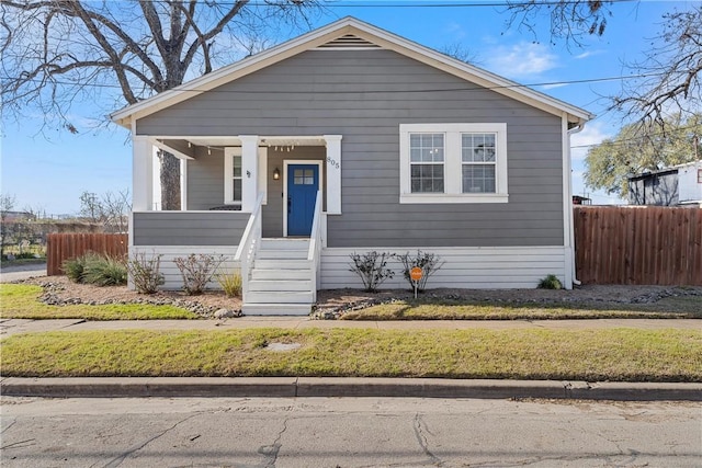 bungalow with covered porch and fence