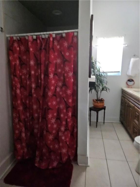 bathroom with tile patterned flooring, vanity, and toilet