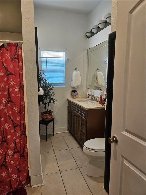 bathroom featuring tile patterned floors, vanity, and toilet