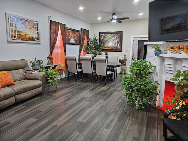 living room featuring dark hardwood / wood-style floors and ceiling fan