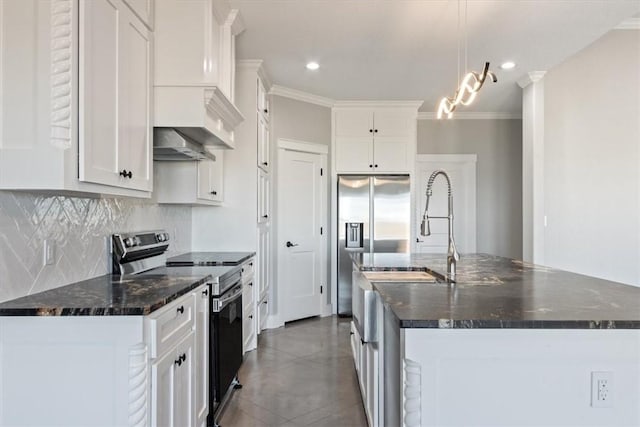 kitchen with a kitchen island with sink, white cabinetry, and stainless steel appliances