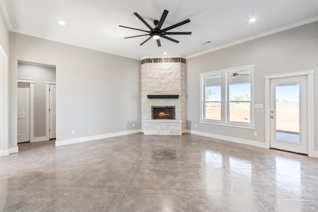 unfurnished living room with ceiling fan, ornamental molding, and a fireplace