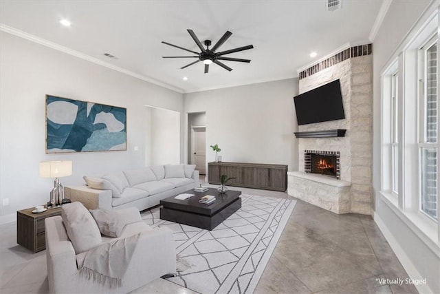 living room with crown molding, a fireplace, and ceiling fan