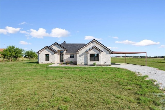 view of front of house with a carport, a rural view, and a front yard