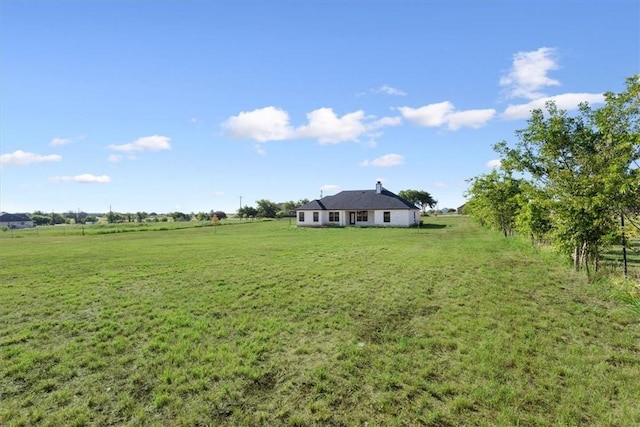 view of yard with a rural view