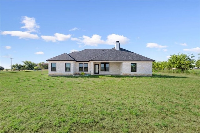 rear view of property with a yard