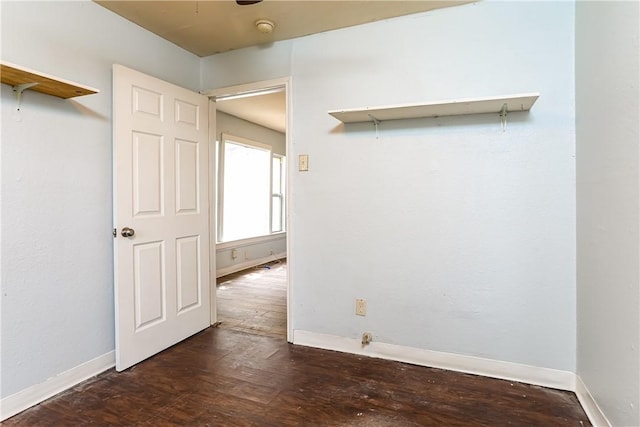 unfurnished room with dark hardwood / wood-style flooring