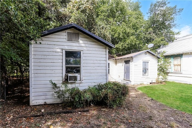 exterior space featuring cooling unit and an outbuilding