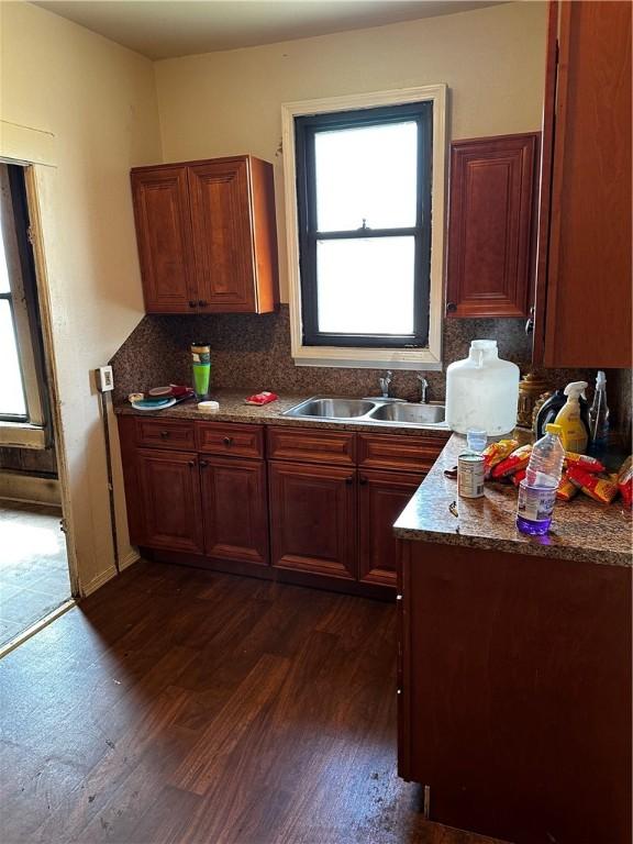 kitchen featuring backsplash, dark hardwood / wood-style floors, and sink