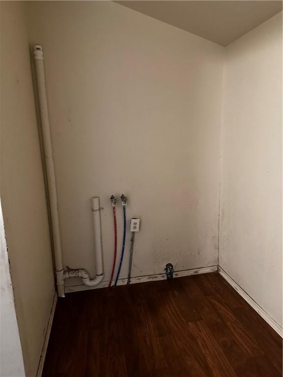 clothes washing area featuring dark hardwood / wood-style flooring