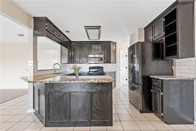 kitchen with kitchen peninsula, light tile patterned floors, black range with electric stovetop, and light stone countertops