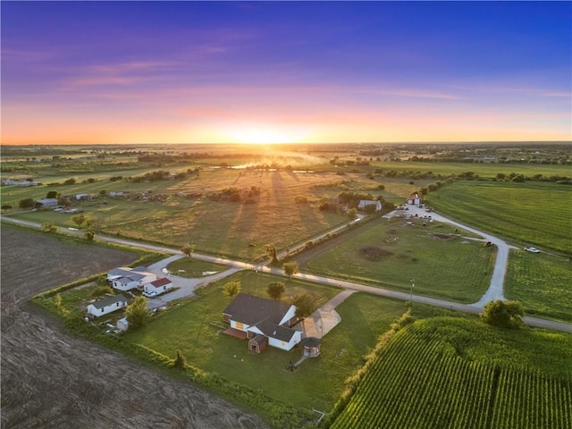 aerial view at dusk featuring a rural view