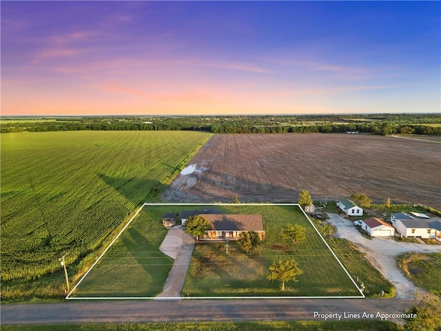 aerial view at dusk featuring a rural view