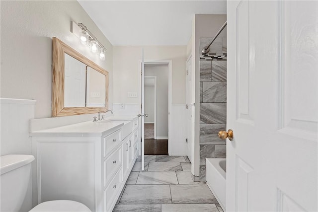 full bathroom featuring vanity, toilet, and tiled shower / bath