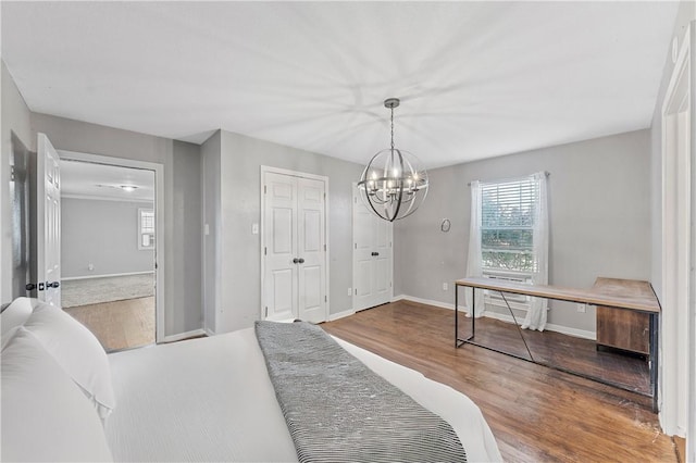 bedroom with hardwood / wood-style flooring and a chandelier