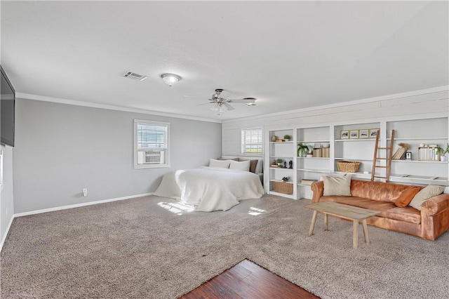 bedroom with ceiling fan, carpet floors, and ornamental molding